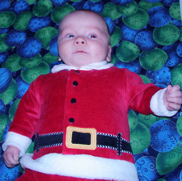 Baby in a Santa suit is trustworthy and cute
