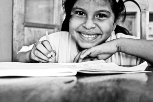 smiling girl writing in a book